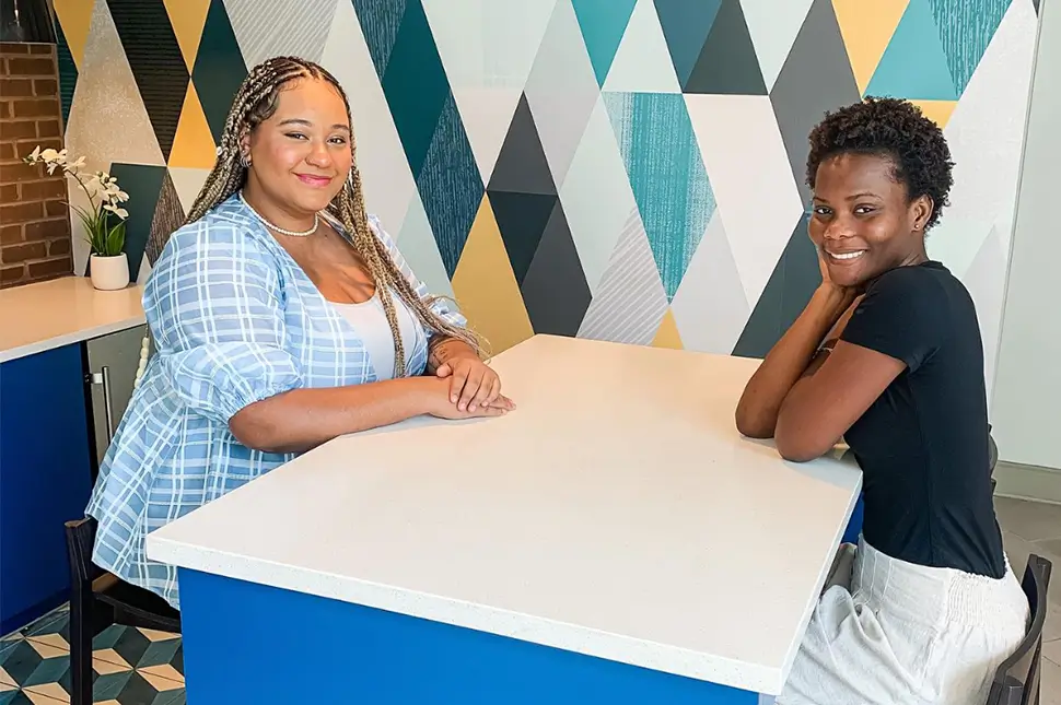 two young women sitting at a table