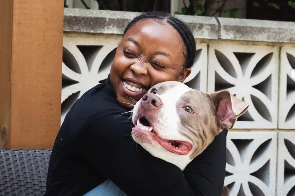 young woman hugging a dog